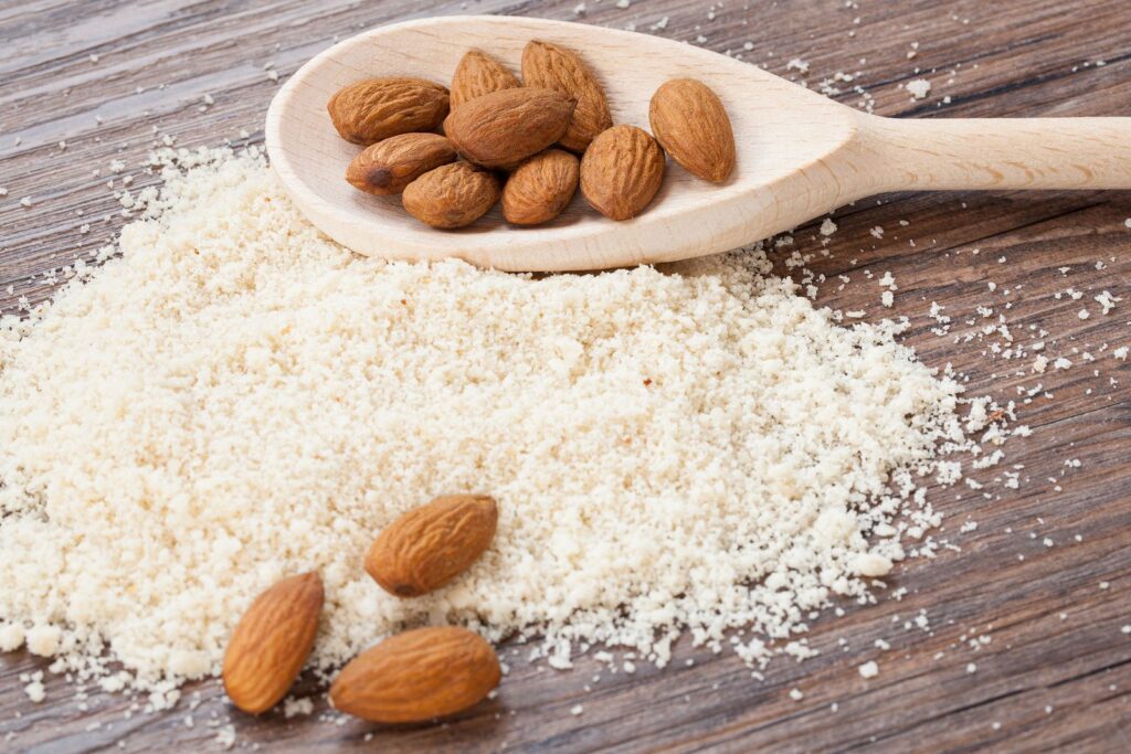 almond flour almonds in a dark wood background